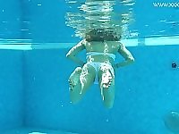 Swimming skinny chick strips naked in the pool